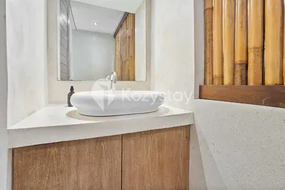 a bathroom with a white sink and a mirror at Bamila Villa by Kozystay - Umalas in Canggu