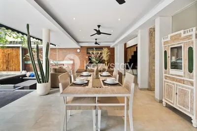 a dining room with a table and chairs at Bamila Villa by Kozystay - Umalas in Canggu