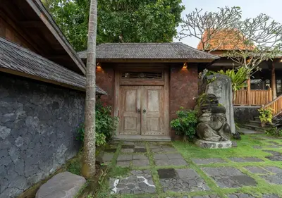 a house with a door with a statue in front of it at Natajiwa Village close to Canggu and Seminyak in Seminyak