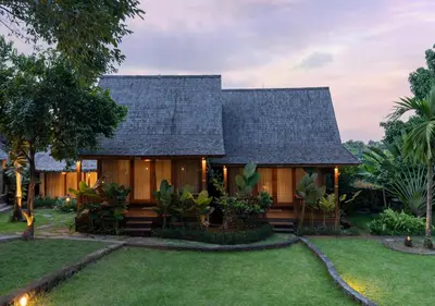 a house with a black roof and a yard at Natajiwa Village close to Canggu and Seminyak in Seminyak