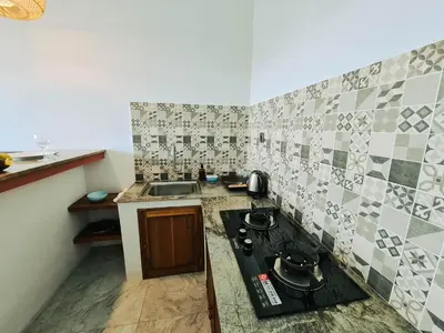 a small kitchen with a stove and a sink at Sejati Villas - Petitenget in Seminyak