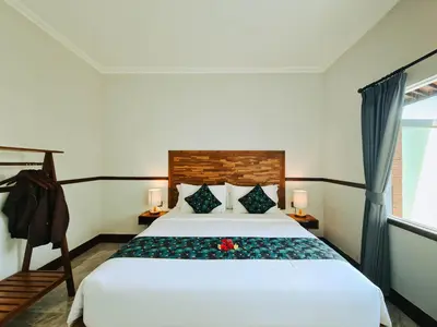 a bedroom with a white bed and a window at Sejati Villas - Petitenget in Seminyak