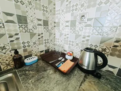 a kitchen counter with a sink and a tray with a coffee maker at Sejati Villas - Petitenget in Seminyak