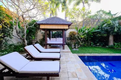 a backyard with a gazebo and a pool at Villa Jepun Seminyak in Canggu