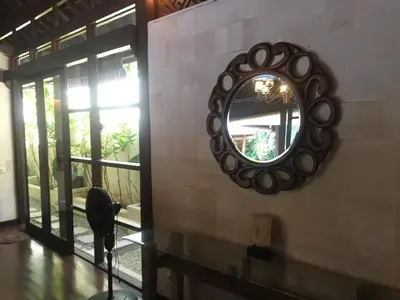 a mirror on the side of a wall with a window at Villa Jepun Seminyak in Canggu