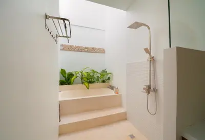 a bathroom with stairs and a shower and a shower at Villa Kembar in Seminyak