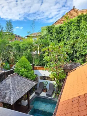 an aerial view of a resort with a swimming pool and trees at Villa Green Manggo Seminyak Bali in Seminyak