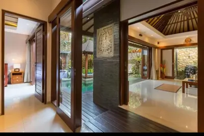 a hallway of a home with sliding glass doors at Villa Green Manggo Seminyak Bali in Seminyak