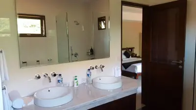 a bathroom with two sinks and a large mirror at Villa Green Manggo Seminyak Bali in Seminyak