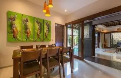 a dining room with a table and chairs at Villa Green Manggo Seminyak Bali in Seminyak