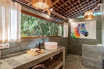 a bathroom with a sink and a painting of a zebra at Villa Madah - Secluded & Romantic Retreat 1BR Near Umalas with Private Pool & View in Kerobokan