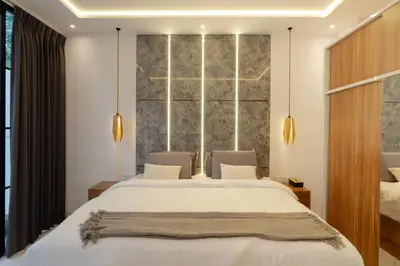 a bedroom with two beds and a large window at Cozy Seminyak Loft 360 Sweet in Seminyak