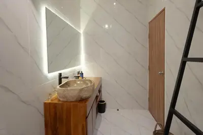 a bathroom with a sink and a mirror at Cozy Seminyak Loft 360 Sweet in Seminyak