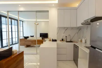 a kitchen and living room with a couch in the background at Cozy Seminyak Loft 360 Sweet in Seminyak