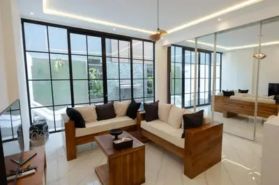 a living room with a couch and some windows at Cozy Seminyak Loft 360 Sweet in Seminyak