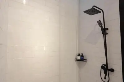a shower with a shower head in a bathroom at Cozy Seminyak Loft 360 Sweet in Seminyak
