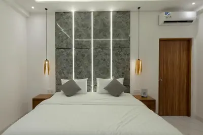 a bedroom with a large white bed with two pillows at Cozy Seminyak Loft 3 Bedroom Private Villa in Seminyak