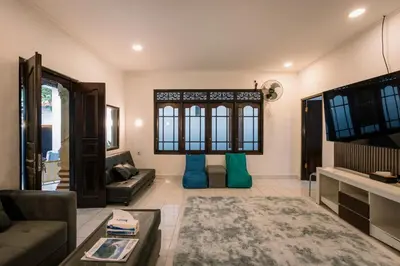 a living room with a couch and a tv at Hawaiian Beach House in Legian