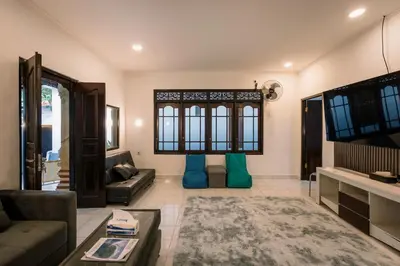 a living room with a couch and a tv at Hawaiian Beach House in Legian