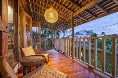 a porch with a chair and a chandelier at Villa Vintage 3 in Canggu