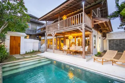 an exterior view of a house with a swimming pool at Villa Vintage 3 in Canggu