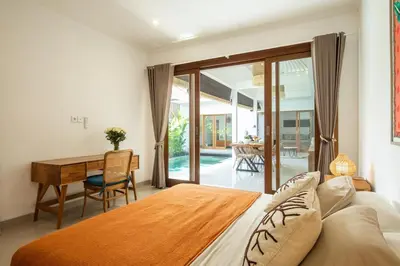 a bedroom with a bed and a desk at Canggu - Villa Romy - 2 Bedrooms - Private Pool in Kerobokan