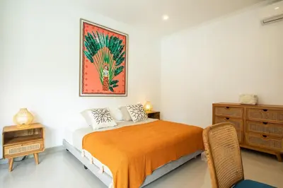 a bedroom with a bed and a painting on the wall at Canggu - Villa Romy - 2 Bedrooms - Private Pool in Kerobokan
