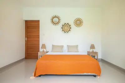 a bedroom with a bed and two mirrors on the wall at Canggu - Villa Romy - 2 Bedrooms - Private Pool in Kerobokan
