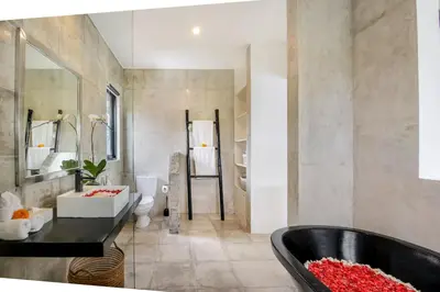 a bathroom with a tub and a sink at Villa Roma in Seminyak