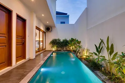 a swimming pool in the middle of a house at Villa Boswellia Seminyak near Double Six Beach in Seminyak