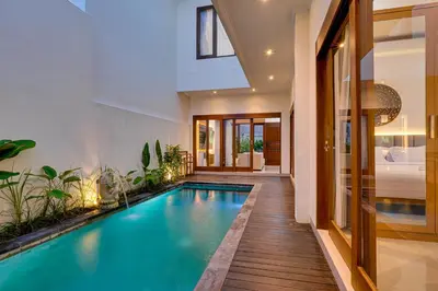 an indoor pool in a home with a house at Villa Boswellia Seminyak near Double Six Beach in Seminyak