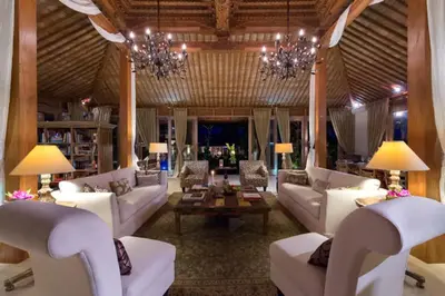 a living room with white furniture and a chandelier at Kudus Boutique Estate in Canggu 100m to Beach in Canggu