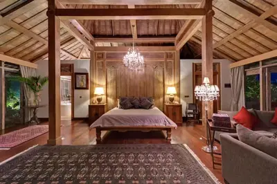 a bedroom with a bed and a living room at Kudus Boutique Estate in Canggu 100m to Beach in Canggu