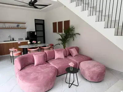 a pink couch sitting in a living room at LUX 2 Bed Villa - Berawa in Canggu
