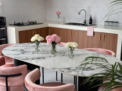 a table with vases of flowers on it in a kitchen at LUX 2 Bed Villa - Berawa in Canggu
