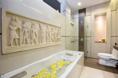 a bathroom with a bath tub with flowers in it at InKuta Residence and Villa in Seminyak