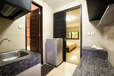 a kitchen with a stainless steel refrigerator and a sink at InKuta Residence and Villa in Seminyak