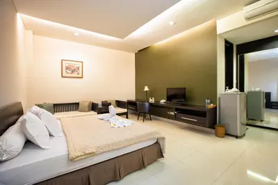 a bedroom with a bed and a television in it at InKuta Residence and Villa in Seminyak