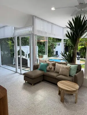 a living room with a couch and a table at White Sands Private Villa in Seminyak