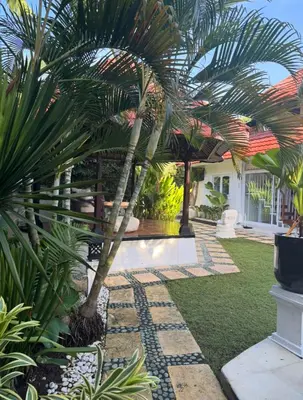 a palm tree in the yard of a house at White Sands Private Villa in Seminyak