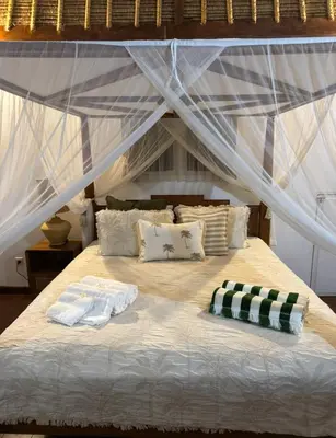 a bed with two towels on top of it at White Sands Private Villa in Seminyak