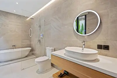 a bathroom with a sink and a toilet and a mirror at New 3 BR Luxury Villa in Umalas in Canggu