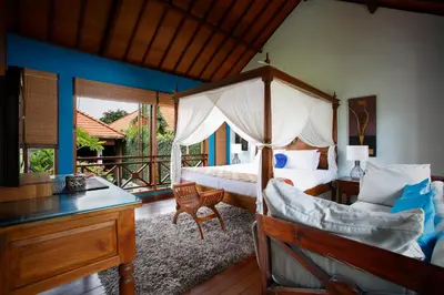 a bedroom with a canopy bed and a desk at Villa SanSam Seminyak in Seminyak