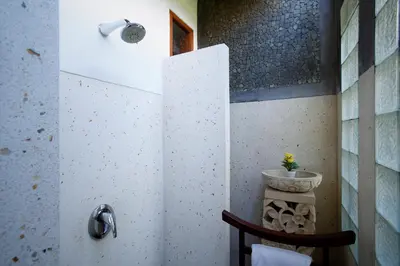 a bathroom with a shower with a toilet in it at Villa SanSam Seminyak in Seminyak