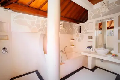 a bathroom with a sink and a shower and a toilet at Villa SanSam Seminyak in Seminyak