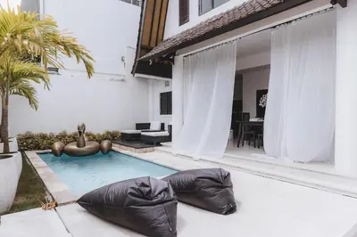 a swimming pool in the backyard of a house at Villa Manis Kecil in Seminyak