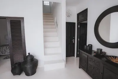 a bathroom with a staircase and a mirror and a sink at Villa Manis Kecil in Seminyak