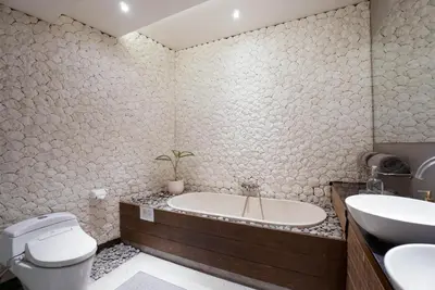 a bathroom with a tub and a toilet and a sink at Villa Duadewi 3BR in the Heart of Seminyak by Santi Management in Seminyak