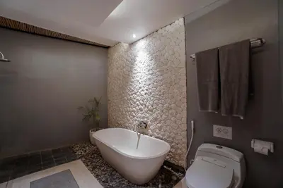 a bathroom with a tub and a toilet and a sink at Villa Duadewi 3BR in the Heart of Seminyak by Santi Management in Seminyak