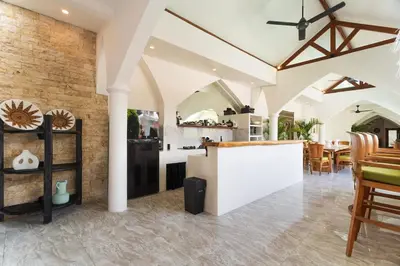 a kitchen and dining room with a brick wall at Villa Nirvana Seminyak in Seminyak